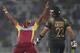West Indies' bowler Krishmar Santokie, left, celebrates the dismissal of Pakistan batsman Ahmed Shehzad during their ICC Twenty20 Cricket World Cup match in Dhaka, Bangladesh, Tuesday, April 1, 2014. (AP Photo/Aijaz Rahi)