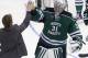 North Dakota goalie Zane Gothberg (31) is congratulated after North Dakota defeated Ferris State 2-1 in two overtimes in a regional final of the NCAA men's college hockey tournament, Saturday, March 29, 2014, in Cincinnati. (AP Photo/Al Behrman)