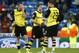 Dortmund's Kevin Grosskreutz, Jonas Hofmann and Julian Schieber, from left, ponder after the Champions League quarterfinal first leg soccer match between Real Madrid and Borussia Dortmund at the Santiago Bernabeu stadium in Madrid, Spain, Wednesday, April 2, 2014. (AP Photo/Andres Kudacki)