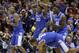 Kentucky's Andrew Harrison (5), Julius Randle (30), Alex Poythress (22) and Aaron Harrison (2) react to a call during the second half of an NCAA Midwest Regional semifinal college basketball tournament game against the Louisville Saturday, March 29, 2014, in Indianapolis. (AP Photo/David J. Phillip)