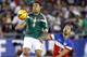 Mexico midfielder Marco Fabian (8) goes up for the ball in front of U.S. defenseman Omar Gonzalez (3) during the first half of an international friendly soccer match Wednesday, April 2, 2014, in Glendale, Ariz. (AP Photo/Rock Scuteri)