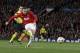 Manchester United's Wayne Rooney shoots a ball during the Champions League quarterfinal first leg soccer match between Manchester United and Bayern Munich at Old Trafford Stadium, Manchester, England, Tuesday, April 1, 2014.(AP Photo/Jon Super)