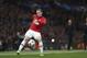 Manchester United's Wayne Rooney controls a ball during the Champions League quarterfinal first leg soccer match between Manchester United and Bayern Munich at Old Trafford Stadium, Manchester, England, Tuesday, April 1, 2014.(AP Photo/Jon Super)