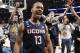 Connecticut's Shabazz Napier (13) celebrates after his team defeated Michigan State 60-54 in a regional final at the NCAA college basketball tournament, Sunday, March 30, 2014, in New York. Napier scored 17 points of his 25 points in the second half. (AP Photo/Frank Franklin II)