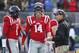 Mississippi football coach Hugh Freeze, right, confers with wide receiver Laquon Treadwell (1) and quarterback Bo Wallace (14) during a timeout in the second half of their NCAA college football game at Vaught-Hemingway Stadium in Oxford, Miss., on Saturday, Nov. 9, 2013. Mississippi won 34-24. (AP Photo/Rogelio V. Solis)