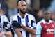 LONDON, ENGLAND - DECEMBER 28: Nicolas Anelka of West Brom touches his sleeve as he celebrates scoring their first goal during the Barclays Premier League match between West Ham United and West Bromwich Albion at Boleyn Ground on December 28, 2013 in London, England. (Photo by Christopher Lee/Getty Images)
