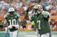 New York Jets quarterback Geno Smith (7) celebrates with teammate Santonio Holmes (10) after his seven-yard touchdown run against the Miami Dolphins during the second quarter of an NFL football game Sunday, Dec. 29, 2013, in Miami Gardens, Fla. (AP Photo/Alan Diaz)