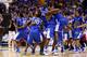 INDIANAPOLIS, IN - MARCH 30: Aaron Harrison #2 of the Kentucky Wildcats celebrates with teammates Julius Randle #30 and Dakari Johnson #44 after defeating the Michigan Wolverines 75 to 72 in the midwest regional final of the 2014 NCAA Men's Basketball Tournament at Lucas Oil Stadium on March 30, 2014 in Indianapolis, Indiana. (Photo by Andy Lyons/Getty Images)