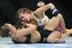 Miesha Tate, top, of Yakima, Wash., punches to Ronda Rousey of Venice, Calif., during the UFC 168 mixed martial arts middleweight championship bout during the UFC 168 mixed martial arts women's bantamweight title fight on Saturday, Dec. 28, 2013, in Las Vegas. Rousey won by a third round tap out. (AP Photo/David Becker)