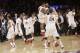 Austin Hollins (20), Deandre Mathieu (4) and Joey King (24) celebrate with teammates after defeating SMU 65-63 in an NCAA college basketball game in the final of the NIT on Thursday, April 3, 2014, in New York. Minnesota won 65-63. (AP Photo/Frank Franklin II)