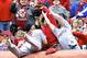St. Louis Cardinals first baseman Matt Adams falls into the stands while trying to catch a foul ball hit by Cincinnati Reds' Chris Heisey that was caught by a fan in the third inning of a baseball game on Thursday, April 3, 2014, in Cincinnati. (AP Photo/Al Behrman)