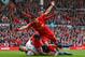 LIVERPOOL, ENGLAND - MARCH 30: Luis Suarez celebrates after Jordan Henderson of Liverpool scored the fourth goal during the Barclays Premier League match between Liverpool and Tottenham Hotspur at Anfield on March 30, 2014 in Liverpool, England. (Photo by Alex Livesey/Getty Images)