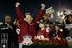 Michigan State football coach Mark Dantonio holds the 100th Rose Bowl championship trophy during halftime at an NCAA college basketball game between Michigan State and Ohio State, Tuesday, Jan. 7, 2014, in East Lansing, Mich. (AP Photo/Al Goldis)