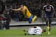 Juventus Turin's Mauricio Isla, left, is tackled by Lyon's goalkeeper Anthony Lopes during their Europa League soccer match in Lyon, central France, Thursday, April 3, 2014. (AP Photo/Laurent Cipriani)