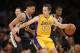 Los Angeles Lakers Steve Nash dribbles the ball as Utah Jazz's Diante Garrett defends during the first half of an NBA basketball game in Los Angeles, Tuesday, Feb. 11, 2014. (AP Photo/Danny Moloshok)