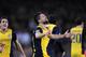 Atletico's Diego, centre celebrates after scoring during a first leg quarterfinal Champions League soccer match between Barcelona and Atletico Madrid at the Camp Nou stadium in Barcelona, Spain, Tuesday April 1, 2014. (AP Photo/Manu Fernandez)