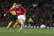 Manchester United's Wayne Rooney shoots a ball during the Champions League quarterfinal first leg soccer match between Manchester United and Bayern Munich at Old Trafford Stadium, Manchester, England, Tuesday, April 1, 2014.(AP Photo/Jon Super)