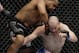Daniel Cormier punches Patrick Cummins during a UFC 170 mixed martial arts light heavyweight fight Saturday, Feb. 22, 2014, in Las Vegas. Cormier won the bout. (AP Photo/Isaac Brekken)