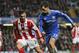 Chelsea's Eden Hazard, right, controls the ball in front of Stoke City's Geoff Cameron, left, during an English FA Cup 4th round soccer match against Stoke City at the Stamford Bridge ground in London, Sunday, Jan. 26, 2014. Chelsea won the match 1-0. (AP Photo/Lefteris Pitarakis)