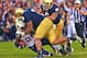 SOUTH BEND, IN - OCTOBER 20: Jamaal Williams #21 of the BYU Cougars is dropped by Stephon Tuitt #7, Louis Nix III #9 and Manti T'eo #5 of the Notre Dame Fighting Irish at Notre Dame Stadium on October 20, 2012 in South Bend, Indiana. Notre Dame defeated BYU 17-14. (Photo by Jonathan Daniel/Getty Images)