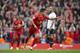 Liverpool's Philippe Coutinho celebrates after scoring against Tottenham during their English Premier League soccer match at Anfield Stadium, Liverpool, England, Sunday March 30, 2014. (AP Photo/Jon Super)