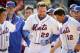 New York Mets first baseman Ike Davis (29) celebrates with his teammates after hitting a walk-off grand slam in the ninth inning of a baseball game against the Cincinnati Reds at Citi Field, Saturday, April 5, 2014, in New York. The Mets won 6-3. (AP Photo/John Minchillo)