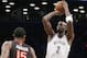 Brooklyn Nets forward Kevin Garnett (2) shoots over Toronto Raptors forward Amir Johnson (15) in the first half of their NBA basketball game at the Barclays Center, Monday, Jan. 27, 2014, in New York. (AP Photo/Kathy Willens)