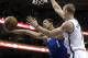 Philadelphia 76ers' Michael Carter-Williams, left, drives to the basket and is fouled by Brooklyn Nets' Mason Plumlee during the second half of an NBA basketball game on Saturday, April 5, 2014, in Philadelphia. The Nets won 105-101. (AP Photo/Michael Perez)