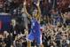 Kentucky guard Aaron Harrison (2) celebrates after making a three-point basket in the final seconds against Wisconsin to win the game 74-73 during their NCAA Final Four tournament college basketball semifinal game Saturday, April 5, 2014, in Arlington, Texas. (AP Photo/Charlie Neibergall)