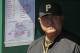 Pittsburgh Pirates manager Clint Hurdle stands in the dugout before the opening day baseball game between the Pittsburgh Pirates and the Chicago Cubs in Pittsburgh Monday, March 31, 2014. The Pirates won 1-0 in ten innings. (AP Photo/Gene J. Puskar)
