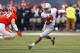 Ohio State running back Dontre Wilson (1) tries to avoid Illinois linebacker Mike Svetina (34) during the second half of an NCAA college football game on Saturday, Nov. 16, 2013, in Champaign, Ill. (AP Photo/Jeff Haynes)