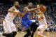 Oklahoma City Thunder forward Kevin Durant (35) drives between Phoenix Suns guard Goran Dragic, right, of Slovenia, and Markieff Morris during the first half of an NBA basketball game on Sunday, April 6, 2014,in Phoenix. (AP Photo/Matt York)