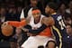 New York Knicks' Carmelo Anthony, left, tries to move around Indiana Pacers' Paul George during the first half of an NBA basketball game at Madison Square Garden on Wednesday, March 19, 2014, in New York. (AP Photo/Seth Wenig)
