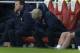 Arsenal's French manager Arsene Wenger, center, looks down during the English Premier League soccer match between Arsenal and Swansea City at the Emirates Stadium in London, Tuesday, March 25, 2014. (AP Photo/Matt Dunham)