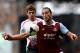 LONDON, ENGLAND - APRIL 06: Andy Carroll of West Ham controls the ball as Jon Flanagan of Liverpool closes during the Barclays Premier League match between West Ham United and Liverpool at Boleyn Ground on April 6, 2014 in London, England. (Photo by Mike Hewitt/Getty Images)