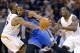 Oklahoma City Thunder forward Kevin Durant, center, collides with Phoenix Suns forward P.J. Tucker (17) during the first half of an NBA basketball game as Suns' Eric Bledsoe watches on Sunday, April 6, 2014, in Phoenix. The Suns won 122-115. (AP Photo/Matt York)
