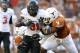 AUSTIN, TX - OCTOBER 15: Running back Jeremy Smith #31 of the Oklahoma State University Cowboys drags along safety Blake Gideon #21 and linebacker Jordan Hicks #3 of the Texas Longhorns in the fourth quarter on October 15, 2011 at Darrell K. Royal-Texas Memorial Stadium in Austin, Texas. Oklahoma State beat Texas 38-26. (Photo by Erich Schlegel/Getty Images)