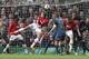 Manchester United's Nemanja Vidic, center, scores the opening goal during the Champions League quarterfinal first leg soccer match between Manchester United and Bayern Munich at Old Trafford Stadium, Manchester, England, Tuesday, April 1, 2014.(AP Photo/Jon Super)
