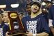 Connecticut guard Shabazz Napier holds the championship trophy after defeating Kentucky 60-54, at the NCAA Final Four tournament college basketball championship game Monday, April 7, 2014, in Arlington, Texas. (AP Photo/David J. Phillip)