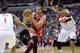 Chicago Bulls center Joakim Noah, center, drives to the basket against Washington Wizards' Trevor Ariza (1) and Trevor Booker (35) during the first half of an NBA basketball game, Saturday, April 5, 2014, in Washington. (AP Photo/Nick Wass)