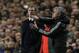Chelsea's manager Jose Mourinho, right gestures to his team watched by Paris Saint-Germain's coach Laurent Blanc during the Champions League quarterfinal second leg soccer match between Chelsea and Paris Saint Germain at Stamford Bridge stadium in London, Tuesday, April 8, 2014. Chelsea won the game 2-0 and advance to the semifinals. (AP Photo/Matt Dunham).