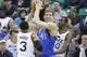 Dallas Mavericks' Dirk Nowitzki (41) passes the ball as Utah Jazz's Trey Burke (3) and Utah Jazz's forward Jeremy Evans (40) defend in the second half during an NBA basketball game Wednesday, March 12, 2014, in Salt Lake City. (AP Photo/Rick Bowmer)