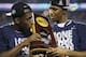 CORRECTS BOATRIGHT TO LASAN KROMAH- Connecticut guard Terrence Samuel, left, and guard Lasan Kromah hold the championship trophy after beating Kentucky 60-54, at the NCAA Final Four tournament college basketball championship game Monday, April 7, 2014, in Arlington, Texas. (AP Photo/David J. Phillip)