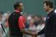 Tiger Woods of the United States, left, and Adam Scott of Australia shake hands after their final round of the British Open Golf Championship at Muirfield, Scotland, Sunday July 21, 2013. (AP Photo/Jon Super)