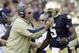 FILE - In this Sept. 8, 2012, file photo, Notre Dame coach Brian Kelly, left, gives a play to quarterback Everett Golson during the first half of an NCAA college football game against Purdue in South Bend, Ind. Golson's high school coach says he believes the quarterback will learn from being suspended by Notre Dame for the fall semester. (AP Photo/Michael Conroy, File)