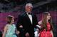 FILE - In this April 5, 2014 file photo provided by the WWE, James Hellwig, aka The Ultimate Warrior, is escorted by his daughters to the stage during the WWE Hall of Fame Induction at the Smoothie King Center in New Orleans. The WWE said Hellwig, one of pro wrestling's biggest stars in the late 1980s, died Tuesday, April 8, 2014. He was 54. (Jonathan Bachman/AP Images for WWE, File)