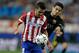 Atletico's David Villa, left, fights for the ball with Barcelona's Marc Bartra during the Champions League quarterfinal second leg soccer match between Atletico Madrid and FC Barcelona in the Vicente Calderon stadium in Madrid, Spain, Wednesday, April 9, 2014. (AP Photo/Paul White)
