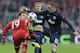 Bayern's Mario Goetze, left, is challenged by Manchester United's Wayne Rooney during the Champions League quarterfinal second leg soccer match between Bayern Munich and Manchester United in the Allianz Arena in Munich, Germany, Wednesday, April 9, 2014. (AP Photo/Matthias Schrader)