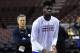 Philadelphia 76ers head coach Brett Brown, left, watches Nerlens Noel as he takes foul shots during warm ups before an NBA basketball against the Brooklyn Nets on Saturday, April 5, 2014, in Philadelphia. (AP Photo/Michael Perez)