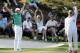 Tennis player Caroline Wozniacki and her fiancee Rory McIlroy, of Northern Ireland, celebrate after Wozniacki putted on the ninth hole during the par three competition at the Masters golf tournament Wednesday, April 9, 2014, in Augusta, Ga. (AP Photo/David J. Phillip)